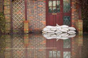 flooded exterior of home with sandbags