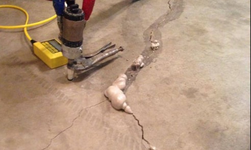 Here you see concrete slab cracks, and Airlift is injecting polyurethane foam to repair it. 