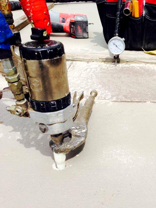 Polyurethane foam injection is being used to fix a concrete foundation crack