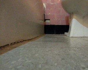 A gap is shown between a wall and the floor