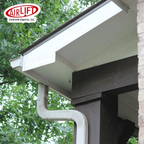 Image shows a downspout on the side of a house. This is part of a proper drainage system.